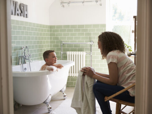 Mom and son having fun during bath time