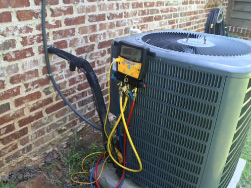 An AC unit in Flower Mound, TX getting maintenance